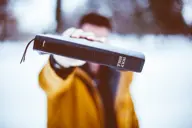 Bible covered in snow, symbolizing purity and resilience